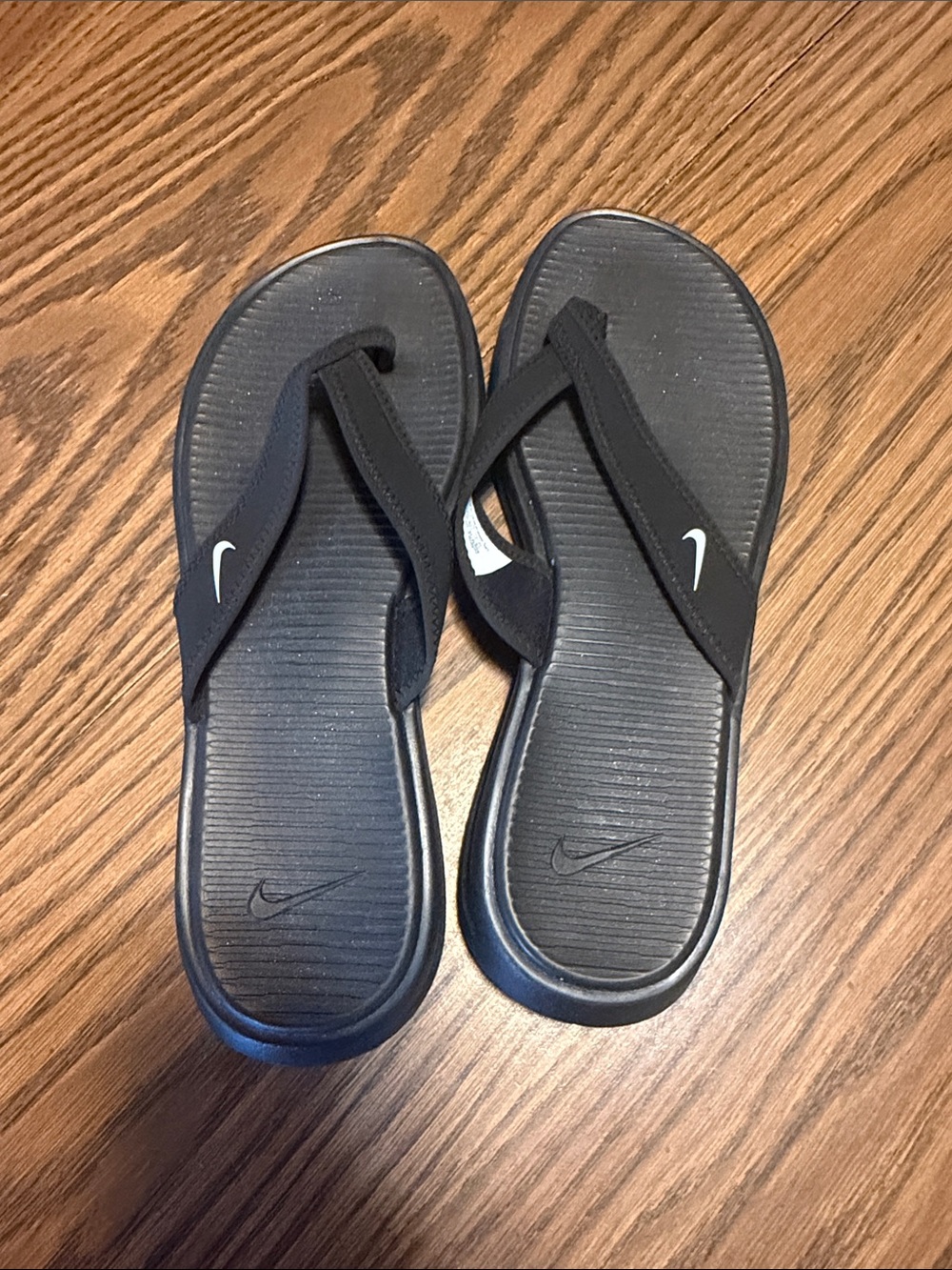Nike Black Flip Flop Sandals with White Swoosh Accent